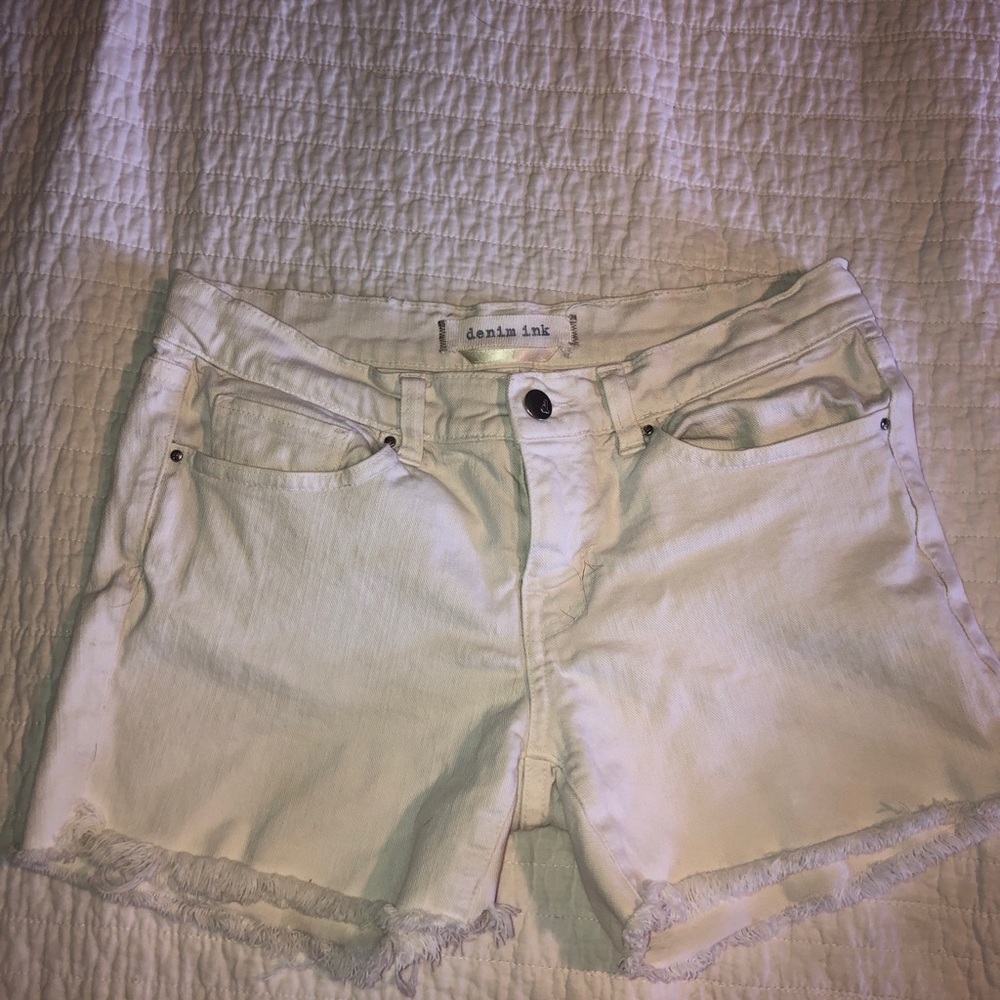 White mid rise shorts.
